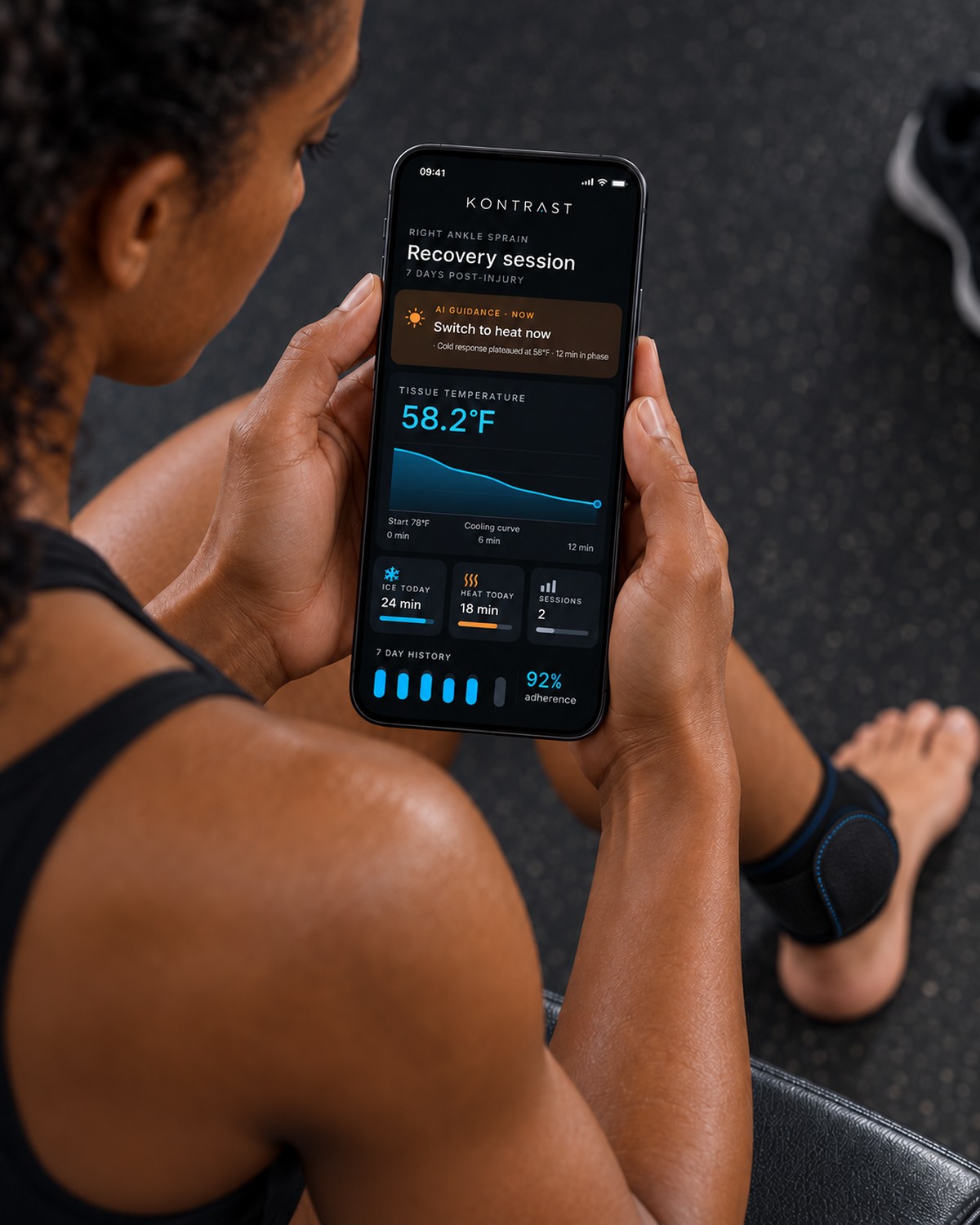 Athlete checking the Kontrast recovery screen and blue cooling curve on her phone.
