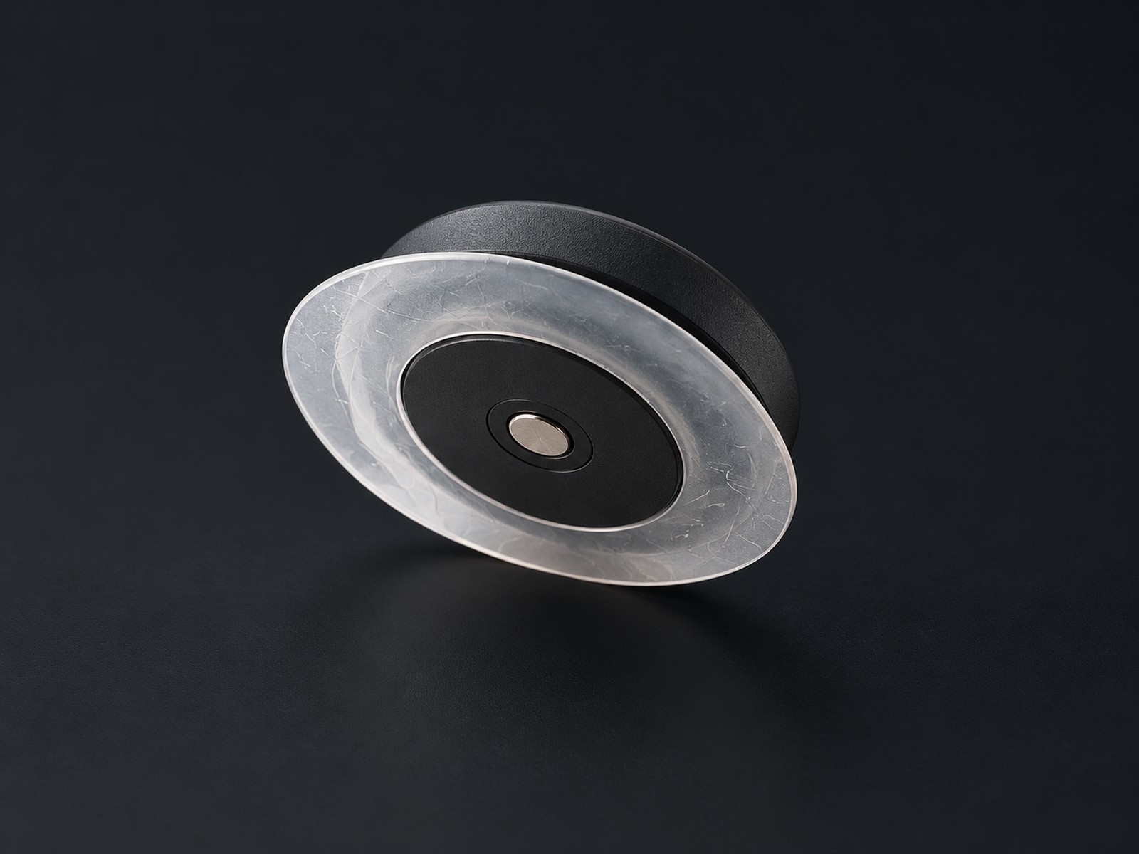 Round matte black Kontrast Core Sensor showing its silicone contact layer and metal sensing contact.